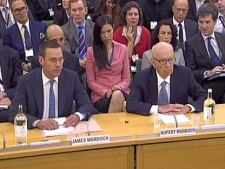 James Murdoch, left, and Rupert Murdoch, give evidence to the Culture, Media and Sport Select Committee on the News of the World phone-hacking scandal in this image taken from TV in Portcullis House in central London on Tuesday, July 19 2011. (AP Photo/PA)