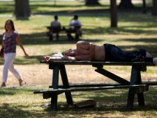 A man sleeps on a picnic table in Toronto's Queen's Park as temperatures hit a high of 41C with the humidex on Wednesday, July 20, 2011. According to Environment Canada, much of the hot weather is blamed on a heat dome, which has settled over parts of Canada and the United States. (THE CANADIAN PRESS/Darren Calabrese)