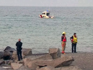 Police stand on the shore of Lake Ontario in Hamilton after a 13-year-old girl drowned Tuesday, July 19, 2011.