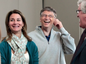 Melinda Gates, left, and husband Bill Gates laugh with Jeff Raikes following speaking at the opening reception of the Bill & Melinda Gates Foundation Thursday, June 2, 2011, in Seattle. The foundation formally opened the new headquarters Thursday evening, moving from scattered nondescript office buildings around Seattle to an architectural showcase in the center of its hometown. (AP Photo/Elaine Thompson)