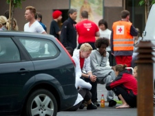 Teenagers who were attending a Labour Party youth wing summer camp on the Utoya island comfort one another outside the Sunvold Hotel, Sundvollen, Norway Saturday July 23, 2011. A Norwegian gunman disguised as a police officer beckoned his victims closer before shooting them one by one, claiming at least 84 lives, in a horrific killing spree on an idyllic island teeming with youths that has left this peaceful Nordic nation in mourning. The island tragedy Friday unfolded hours after a massive explosion ripped through a high-rise building housing the prime minister's office, killing seven people. (AP Photo/Scanpix/Bjern Larsson Rosvall) 