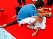 Italy's Edoardo Stochino lies exhausted after pulling out of the men's 25 km Open Water event at the FINA Swimming World Championships at Jinshan Beach in Shanghai, China, Saturday, July 23, 2011. (AP Photo/Ng Han Guan)
