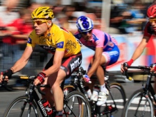 Cadel Evans of Australia, wearing the overall leader's yellow jersey, left, races along the Champs Elysees during the 21st stage of the Tour de France cycling race over 95 kilometers (59 miles) starting in Creteil and finishing in Paris, France, Sunday July 24, 2011. (AP Photo/Laurent Rebours)