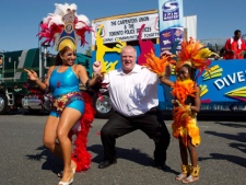 Toronto Mayor Rob Ford (centre) dances with participants ahead of the Toronto Caribbean Carnival in Toronto on Saturday July 30, 2011. (THE CANADIAN PRESS/Chris Young)