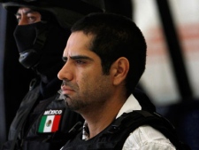 Jose Antonio Acosta Hernandez, 33, is presented to the media by federal police officers in Mexico City, Sunday July 31, 2011. According to federal officials, Acosta, nicknamed "El Diego," is a key drug cartel figure, who acknowledged ordering 1,500 killings. He is also a suspect in last year's slaying of a U.S. consulate employee near a border crossing in Ciudad Juarez. Authorities identified Acosta as head of La Linea, a gang of hit men and corrupt police officers who act as enforcers for the Juarez Cartel. (AP Photo/Marco Ugarte)