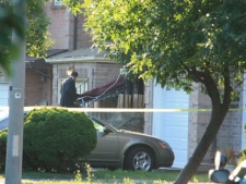 Police are at the scene of Cottonwood Court on August 2, 2011. Two people at the home were killed.