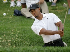 Tiger Woods chips from the sand to the 15th green during practice for the Bridgestone Invitational golf tournament at Firestone Country Club in Akron, Ohio on Wednesday, Aug. 3, 2011. (AP Photo/Amy Sancetta)
