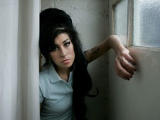 In this Feb. 16, 2007 file photo, British singer Amy Winehouse poses for photographs after being interviewed by The Associated Press at a studio in north London, Friday, Feb. 16, 2007. British police say singer Amy Winehouse has been found dead at her home in London on Saturday, July 23, 2011. The singer was 27 years old. (AP Photo/Matt Dunham)