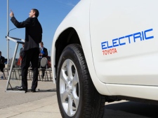 Ontario Premier Dalton McGuinty points to the sun, referering to solar power in front of a Toyota RAV4 EV (electric vehicle) on display for the announcement that the Toyota Woodstock plant is being chosen to produce the vehicle in Woodstock, Ontario, Freday, August 5, 2011.(THE CANADIAN PRESS/Dave Chidley)