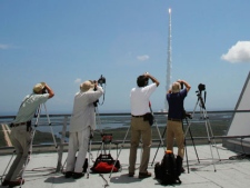 Photographers track an Atlas V rocket with the Juno spacecraft as it lifts off from Space Launch Complex-41 in Cape Canaveral, Fla. on Friday, Aug. 5, 2011. NASA launched the spacecraft atop an unmanned rocket that blasted into a clear midday sky as scientists cheered and yelled "Go Juno!" It was the first step in Juno's 1.7 billion-mile voyage to the gas giant Jupiter, just two planets away but altogether different from Earth and next-door neighbor Mars. (AP Photo/Terry Renna)