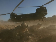 US soldiers from the 2nd Brigade, 87th Infantry Regiment, 10th Mountain Division, secure the area after existing a Chinoonk helicopter, Helmand Province, southern Afghanistan, in this Sunday, June 18, 2006 file photo. Insurgents shot down a U.S. military helicopter Saturday Aug. 6, 2011 similar to this one shown during fighting in eastern Afghanistan, killing 30 Americans, most of them belonging to the same elite Navy SEALs unit that killed Osama bin Laden, as well as seven Afghan commandos, U.S. officials said. It was the deadliest single loss for American forces in the decade-old war. (AP Photo/Rodrigo Abd, File)