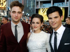 In this June 24, 2010 file photo, from left, Robert Pattinson, Kristen Stewart and Taylor Lautner arrive at the premiere of "The Twilight Saga: Eclipse" in Los Angeles. "The Twilight Saga," Taylor Swift and Selena Gomez are expected to sail away with a few surfboard-shaped trophies at Sunday's Teen Choice Awards. The vampire saga and pop princesses are among the leading nominees at the fan-favorite ceremony. Gomez is set to perform, while Swift will receive the ultimate choice award for her contributions to the entertainment industry. (AP Photo/Matt Sayles, File)