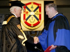 Former Prime Minister Jean Chretien is congratulated by Queen's University Chancellor Charles Baillie after recieving an honourary degree from the University, in Kingston Ont. Thursday May 27, 2004. (CP Photo/Tom Hanson)