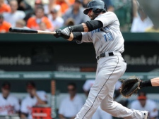 Toronto Blue Jays' Jose Bautista follows through on a two-run double against the Baltimore Orioles in the third inning of a baseball game on Sunday, Aug. 7, 2011, in Baltimore. (AP Photo/Gail Burton) 