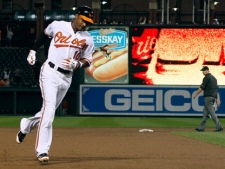 Baltimore Orioles' Adam Jones rounds third base after hitting a two-run home run in the sixth inning of a baseball game against the Toronto Blue Jays in Baltimore, Saturday, Aug. 6, 2011. Baltimore beat Toronto 6-2. (AP Photo/Patrick Semansky)