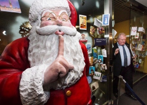 Toronto Mayor Rob Ford walks by a giant statue of Santa as he leaves city hall in Toronto on Friday, Dec. 13, 2013. (The Canadian Press/Mark Blinch)