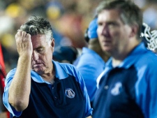 Toronto Argonauts head coach Jim Barker, left, reacts on the sidelines moments after being defeated by the Hamilton Tiger-Cats during second half CFL football action in Hamilton, Ont., on Saturday, August 13, 2011. (THE CANADIAN PRESS/Nathan Denette)