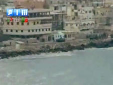 In this image taken from video made available Sunday Aug. 14, 2011, by Shaam News Network (SHAMSNN), in which they purport to show armoured vehicles as they take up positions along the water front of Latakia, Syria. The intense operation in Latakia, a key port city once known as a summer tourist draw, is part of a brutal government crackdown on several Syrian cities meant to root out protesters demanding the ousting of President Bashar Assad. (AP Photo / SHAMSNN)