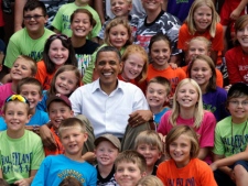 President Barack Obama poses for a photo with summer school kids, Monday, Aug. 15, 2011, in Chatfield, Minn., during his three-day economic bus tour. (AP Photo/Carolyn Kaster)