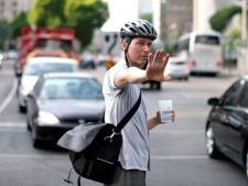 A member of the public directs traffic at a busy intersection during rush hour as traffic lights fail in downtown Toronto as a power outage leaves much of the city core without electricity on Monday July , 2010. THE CANADIAN PRESS/Chris Young