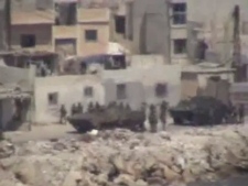 This image taken from amateur video made available Tuesday Aug. 17, 2011 purports to show armored vehicles as they take up positions along the water front of Latakia, Syria on Monday. Activists say 15 people have died in shootings across Syria Monday including at least five in the coastal city of Latakia where military operations where in their fourth day. Residents report hearing heavy machine gun fire in several districts Tuesday including the impoverished al-Ramel and al-Shaab areas. (AP Photo)