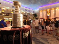 In this image provided by Tom Briglia, hockey fans take photos of the NHL's Stanly Cup trophy in the hotel lobby at Caesars Atlantic City on Tuesday, Aug. 9, 2011 in Atlantic City, N.J. The trophy was brought into town by Boston Bruins' Dennis Seidenberg, who is a summer resident of nearby Margate City. (AP Photo/Tom Briglia)