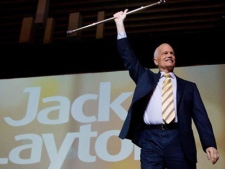 NDP Leader Jack Layton raises his cane as he takes to the stage to deliver his keynote speech to the party's 50th anniversary convention in Vancouver, B.C., on Sunday June 19, 2011. Layton died at his Toronto home this morning at the age of 61. THE CANADIAN PRESS/Darryl Dyck