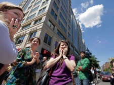 Office workers gather on the sidewalk in downtown Washington, Tuesday, Aug. 23, 2011, moments after a 5.9 magnitude tremor shook the nation's capitol. The earthquake centered northwest of Richmond, Va., shook much of Washington, D.C., and was felt as far north as Rhode Island and New York City. (AP Photo/J. Scott Applewhite)