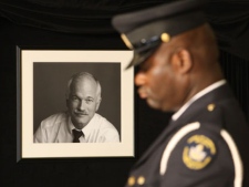 A House of Commons honour guard stands by the casket of Jack Layton as the body of the late NDP leader lies in state on Parliament Hill in Ottawa on Wednesday, Aug. 24, 2011. (THE CANADIAN PRESS/Ryan Remiorz)