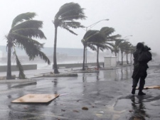 A man walks along the waterfront as Hurricane Irene passes to the east of Nassau on New Providence Island in the Bahamas, Thursday, Aug. 25, 2011. (AP / Lynne Sladky)