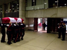 The casket containing NDP leader Jack Layton arrives at Toronto's City Hall on Thursday August 25, 2011, to lie in repose ahead of Saturday's state funeral. THE CANADIAN PRESS/Chris Young