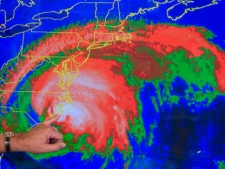 The finger of National Hurricane Center Director Bill Read points to the landfall of Hurricane Irene's eye at Cape Lookout, N.C., using a Telestrator, Saturday, Aug. 27, 2011, at the hurricane center in Miami. (AP Photo/Andy Newman)