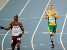 South Africa's Oscar Pistorius, right, crosses the finish line in a men's 400-metre semifinal with Qatar's Femi Ogunode at the World Athletics Championships in Daegu, South Korea, Monday, Aug. 29, 2011. (AP Photo/Martin Meissner)