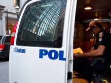 A police officer, from the Forensic Identification Service, sits in his van outside the 1 King West apartment in Toronto after former NHL player Wade Belak was found dead on Wednesday August 31, 2011. Former NHL tough guy Belak has been found dead in Toronto, the third NHL tough guy to die in 2011 and second in less than a month. THE CANADIAN PRESS/Chris Young