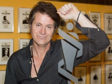 Jim Cuddy of the group Blue Rodeo poses by a Juno awards logo in Toronto on Tuesday October 25, 2010. (THE CANADIAN PRESS/Frank Gunn)