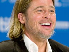 Actor Brad Pitt laughs during a press conference for the film 'Moneyball' at the Toronto International Film Festival in Toronto Friday, Sept. 9, 2011. (AP Photo/The Canadian Press - Darren Calabrese)