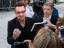 Bono greets fans as he arrives for the gala screening of "From the Sky Down" at the Toronto International Film Festival on Thursday, Sept. 8, 2011. (THE CANADIAN PRESS/Frank Gunn)