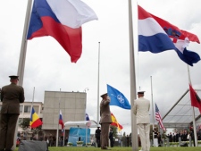 Flags fly at half staff during a ceremony to commemorate the victims of terrorism on the ten-year anniversary of the 9/11 terrorist attacks, at NATO headquarters in Brussels, Sunday, Sept. 11, 2011. (AP Photo/Yves Logghe)
