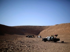 Former rebel fighters rest in an area near the frontline of Bani Walid, Libya, Sunday, Sept. 11, 2011. (AP Photo/Alexandre Meneghini)