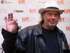 Neil Young waves as he arrives for new movie "Neil Young Journeys" at the Toronto International Film Festival in Toronto on Monday, Sept., 12, 2011. (THE CANADIAN PRESS/Nathan Denette)
