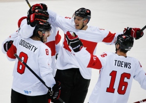 Team Canada celebrates a third period goal against Latvia during a men's quarterfinal ice hockey game at the 2014 Winter Olympics,  in Sochi, Russia, Wednesday, Feb. 19, 2014. (AP / Mark Humphrey)