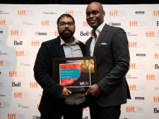 Ian Harnarine, left, is awarded the Best Canadian Short Film Award for his film "Doubles With Slight Pepper" by tiff Co-Director Cameron Bailey during the closing brunch of the Toronto International Film Festival in Toronto, Sunday Sept. 18, 2011. THE CANADIAN PRESS/ Aaron Vincent Elkaim