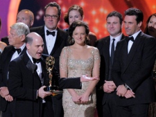 Cast and crew of Mad Men and creator Matthew Weiner, front left, accept the award for outstanding drama series at the 63rd Primetime Emmy Awards on Sunday, Sept. 18, 2011 in Los Angeles. (AP Photo/Mark J. Terrill)