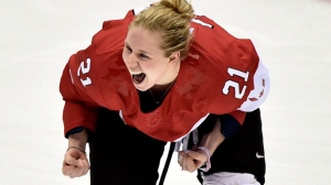 Canada's Haley Irwin celebrates teammate Marie-Philip Poulin's winning overtime goal during women's hockey final action at the 2014 Sochi Winter Olympics in Sochi, Russia on Thursday, February 20, 2014. (Nathan Denette/The Canadian Press)
