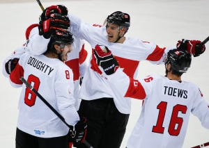 Team Canada celebrates a third period goal against Latvia during a men's quarter-final ice hockey game at the 2014 Winter Olympics Wednesday, Feb. 19, 2014, in Sochi, Russia. (AP Photo/Mark Humphrey)