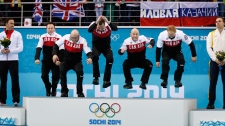 Canadian men jump on the podium after winning gold