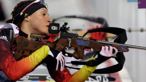 Germany's Evi Sachenbacher-Stehle prepares to shoot during the women's biathlon 15k individual race, at the 2014 Winter Olympics, Friday, Feb. 14, 2014, in Krasnaya Polyana, Russia. (AP Photo/Lee Jin-man)