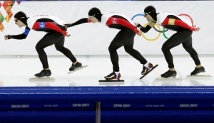 Speedskaters from Canada, left to right, Denny Morrison, Mathieu Giroux and Lucas Makowsky skate to take a fourth place in the men's team pursuit race against Poland at the Adler Arena Skating Center at the 2014 Winter Olympics, Saturday, Feb. 22, 2014, in Sochi, Russia. (AP Photo/Matt Dunham)