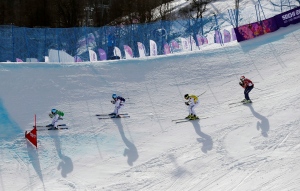 Jean Frederic Chapuis of France, left, leads compatriots Arnaud Bovolenta, second left, and Jonathan Midol, third left, and Canada's Brady Leman in the men's ski cross final at the Rosa Khutor Extreme Park, at the 2014 Winter Olympics, Thursday, Feb. 20, 2014, in Krasnaya Polyana, Russia. (AP Photo/Sergei Grits)