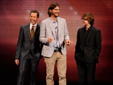 In this May 18, 2011, file publicity image released by CBS, the cast of "Two and a Half Men," from left, Jon Cryer, Ashton Kutcher, and Angus T. Jones are shown during their presentation at CBS' upfront at Carnegie Hall in New York. (AP Photo/CBS, Jeffrey R. Staab)